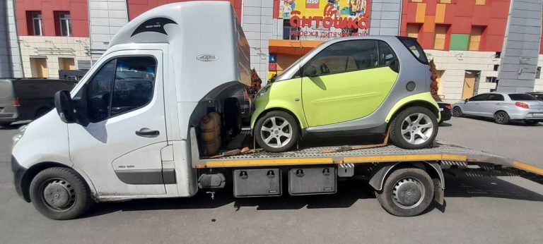 эвакуатор везет маленькое авто
